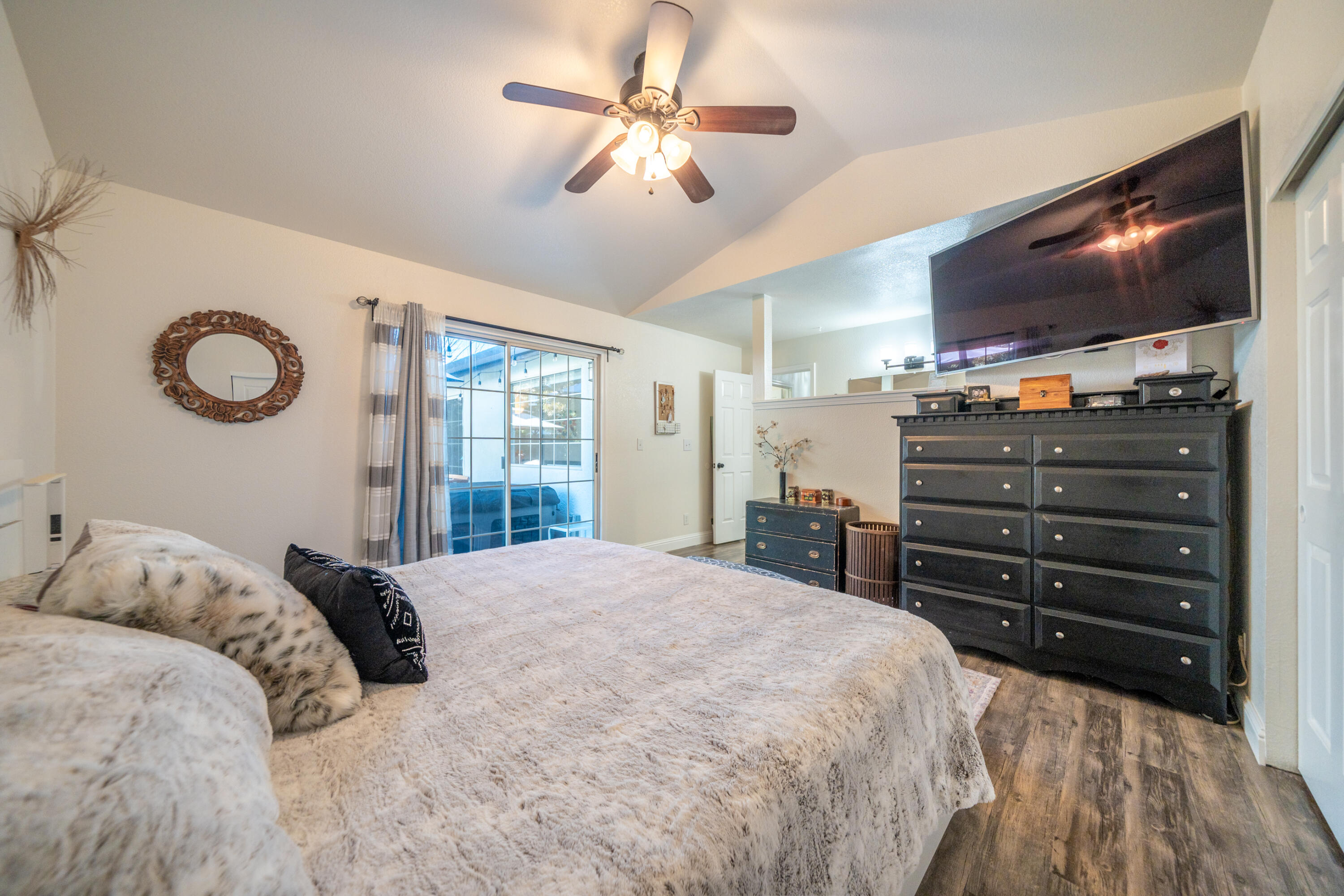 874 Spaniel Drive Redding, CA 96003 - Photo 20 of 41 a bedroom with a bed and a flat screen tv