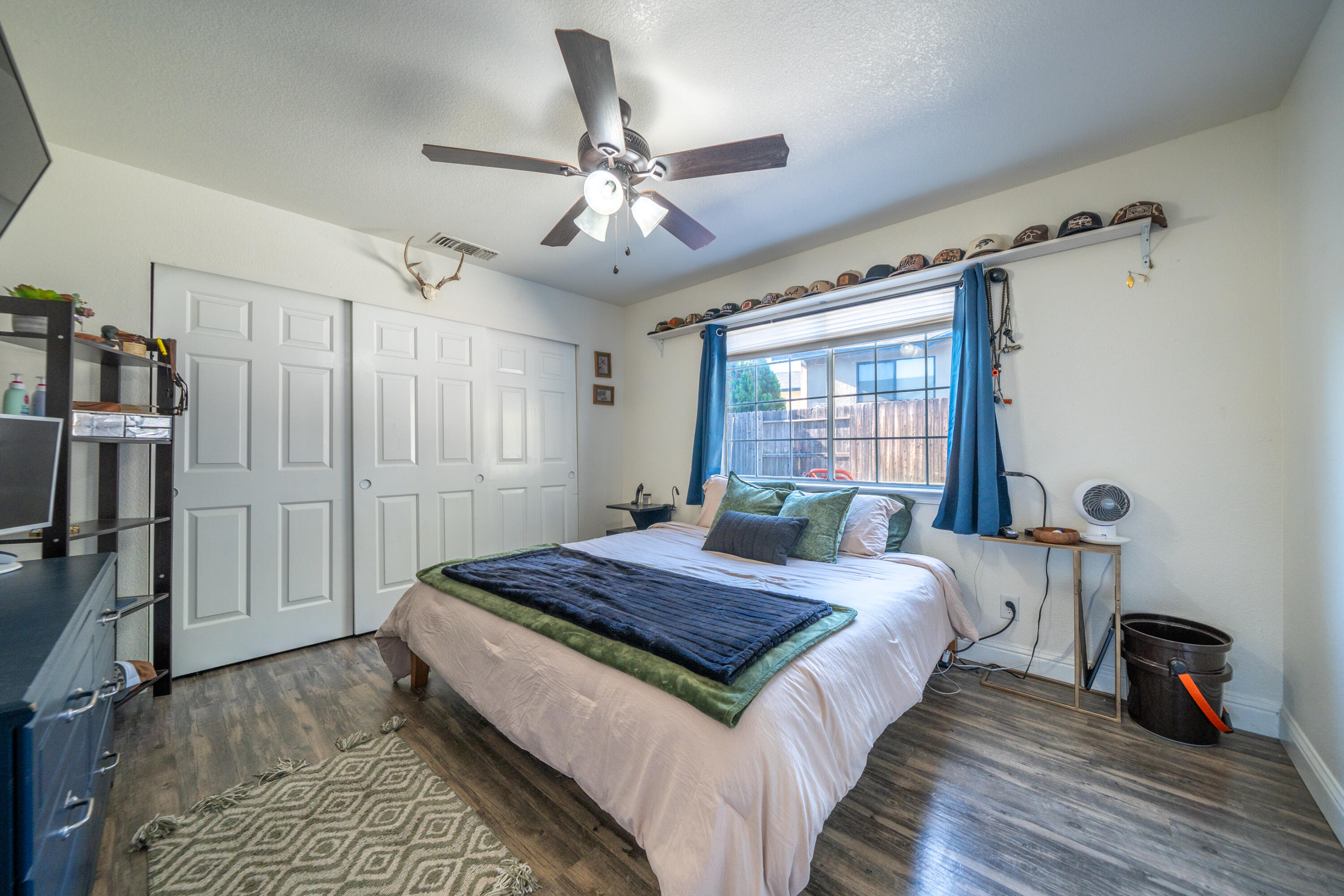 874 Spaniel Drive Redding, CA 96003 - Photo 23 of 41 a bedroom with a bed and a chandelier