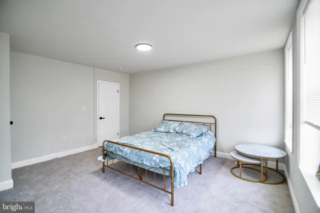 a bedroom with a bed and a table