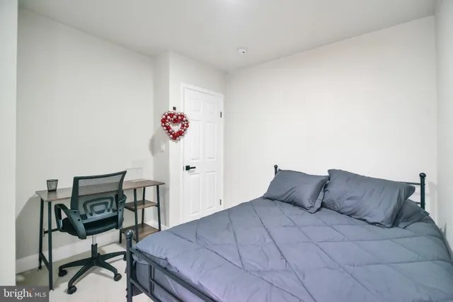 a bedroom with a bed and a table in it