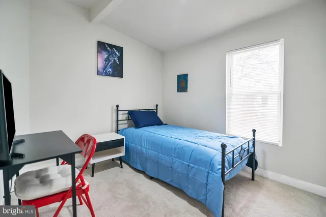 a bedroom with a bed and a chair