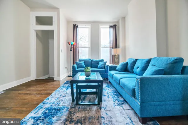 a living room with furniture and a rug