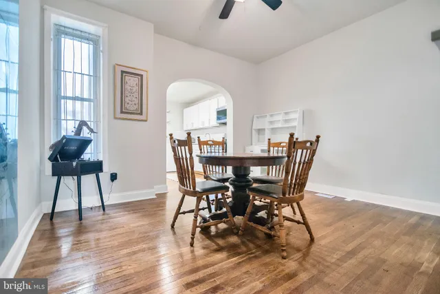 a view of a dining room with furniture and wooden floor