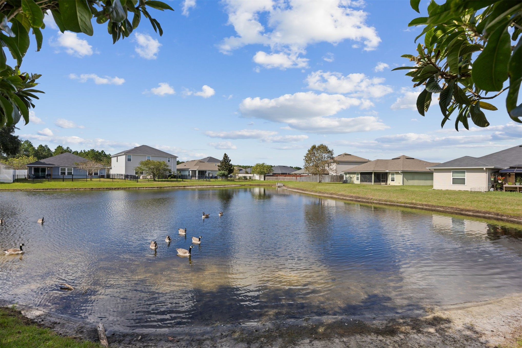 94037 Last Lane Yulee, FL 32097 - Photo 33 of 38 a view of a lake with houses