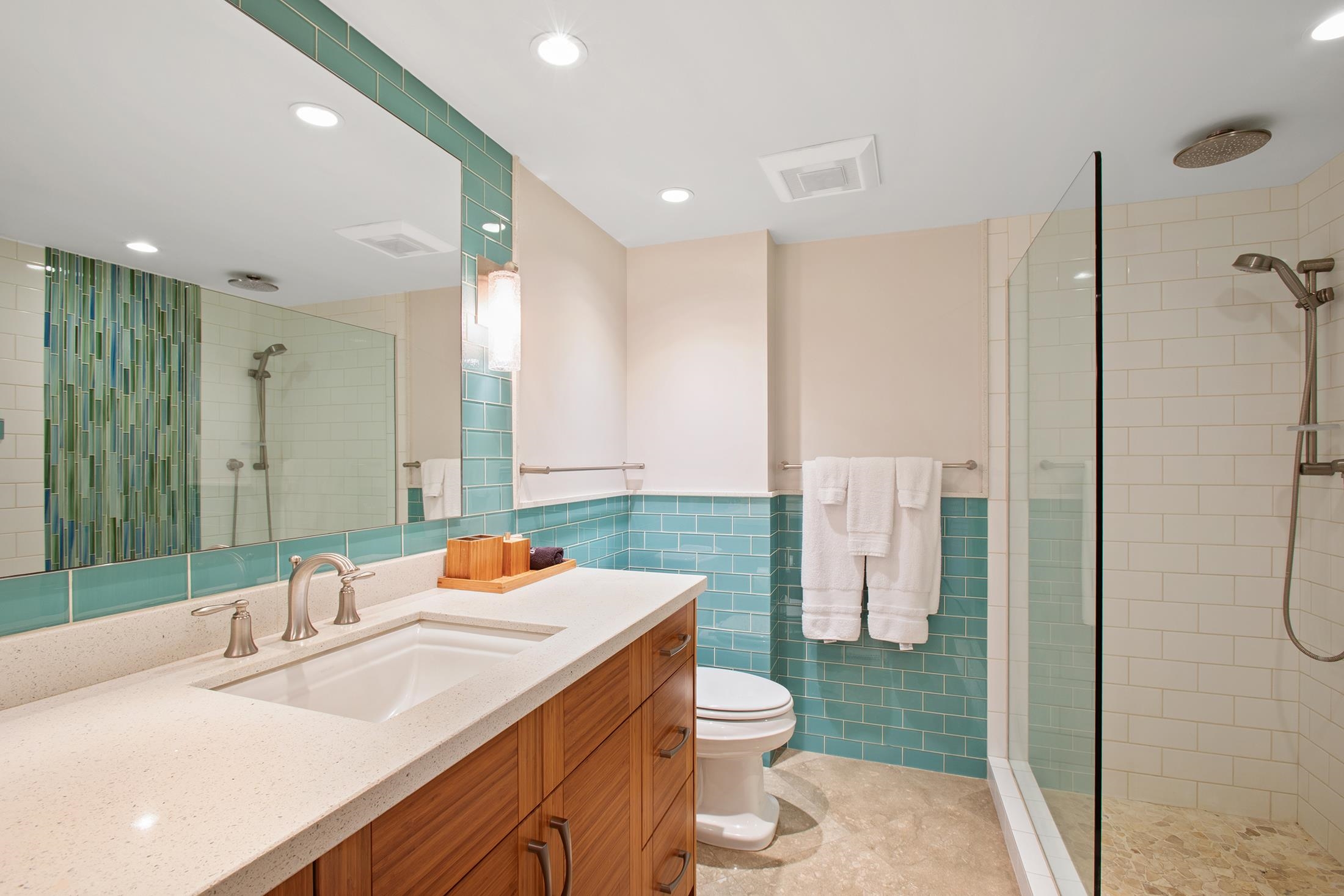 4850 Makena Alanui Road, Unit F207 Kihei, HI 96753 - Photo 14 of 34 a bathroom with a sink a toilet a shower and a mirror