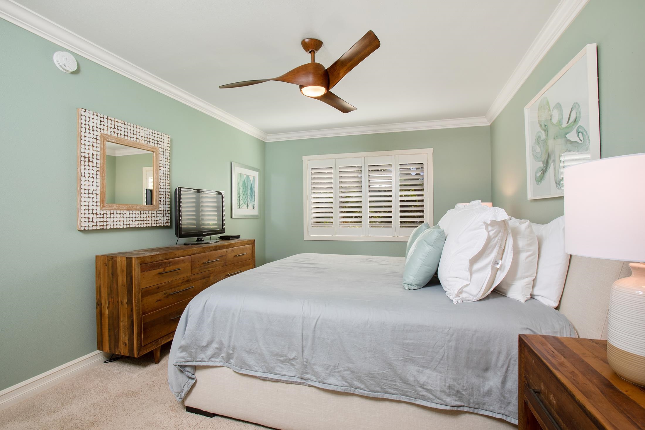 4850 Makena Alanui Road, Unit F207 Kihei, HI 96753 - Photo 17 of 34 a bedroom with a bed and wooden floor