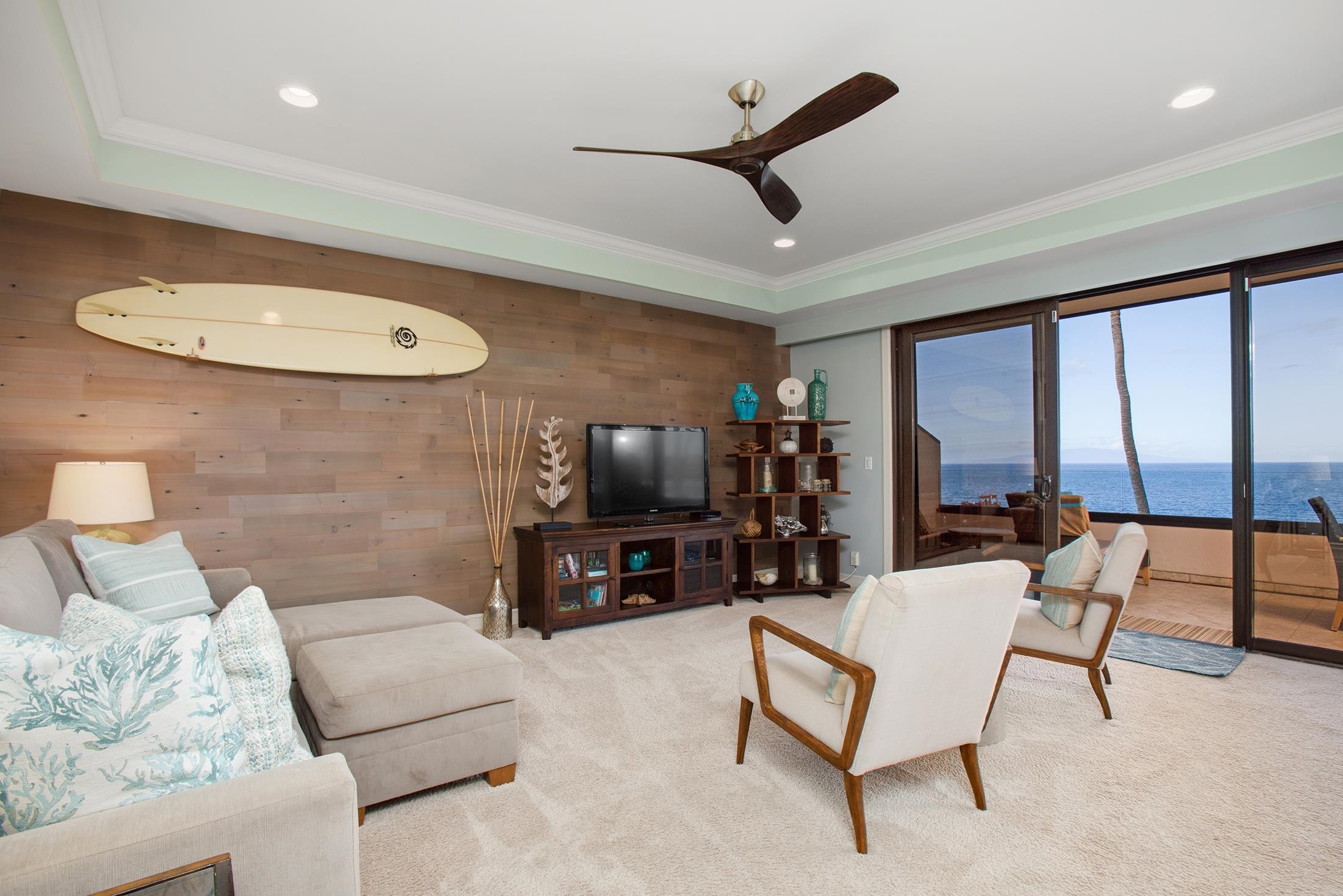 4850 Makena Alanui Road, Unit F207 Kihei, HI 96753 - Photo 5 of 34 a living room with furniture and a flat screen tv