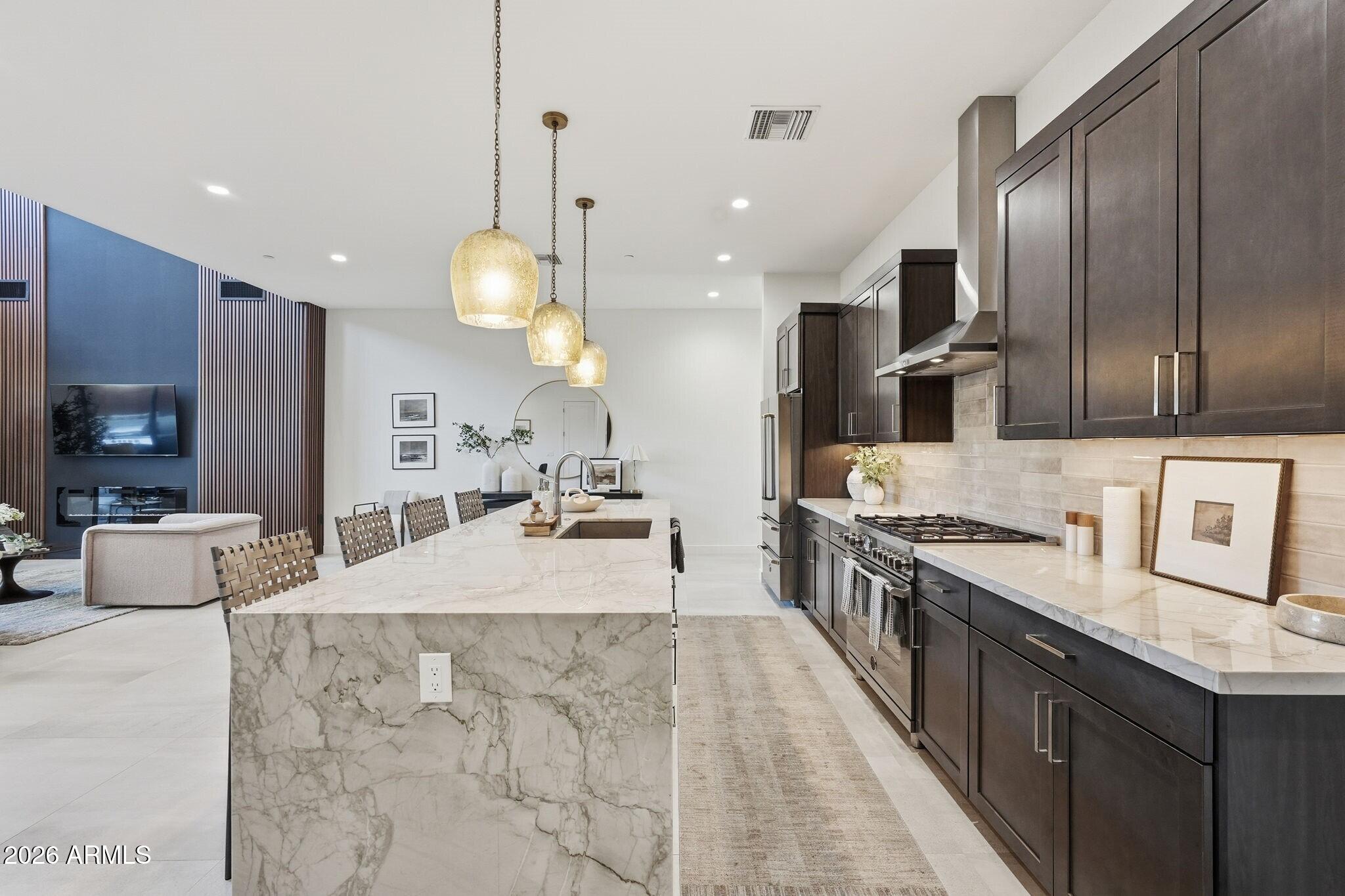 6525 East Cave Creek Road, Unit 304 Cave Creek, AZ 85331 - Photo 8 of 31 a large kitchen with stainless steel appliances kitchen island granite countertop a stove a sink and a refrigerator