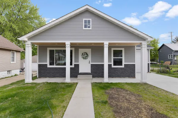 a front view of a house with a yard and porch