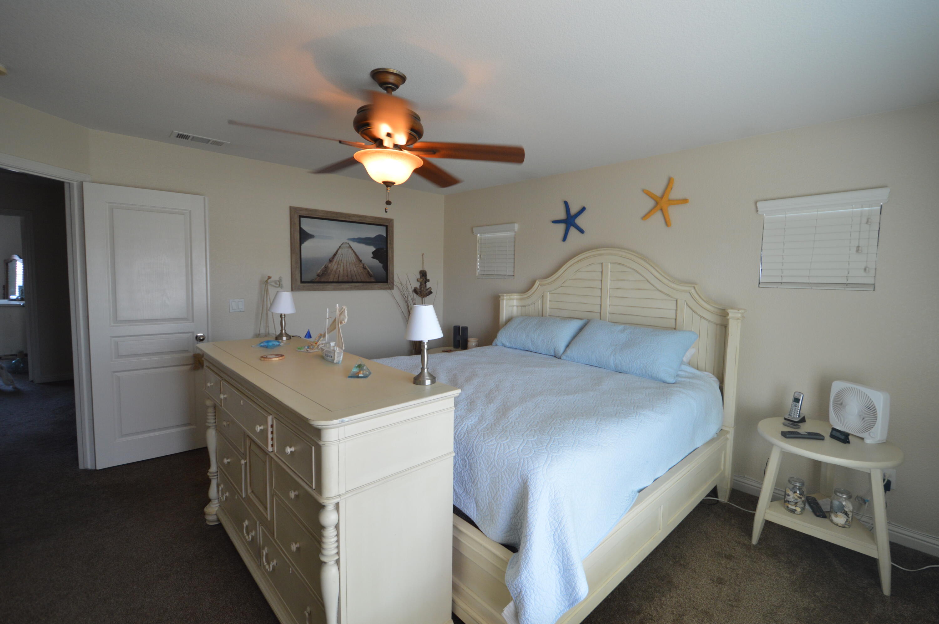 2316 Point Sal Loop Lompoc, CA 93436 - Photo 25 of 36 a bedroom with a bed and a chandelier