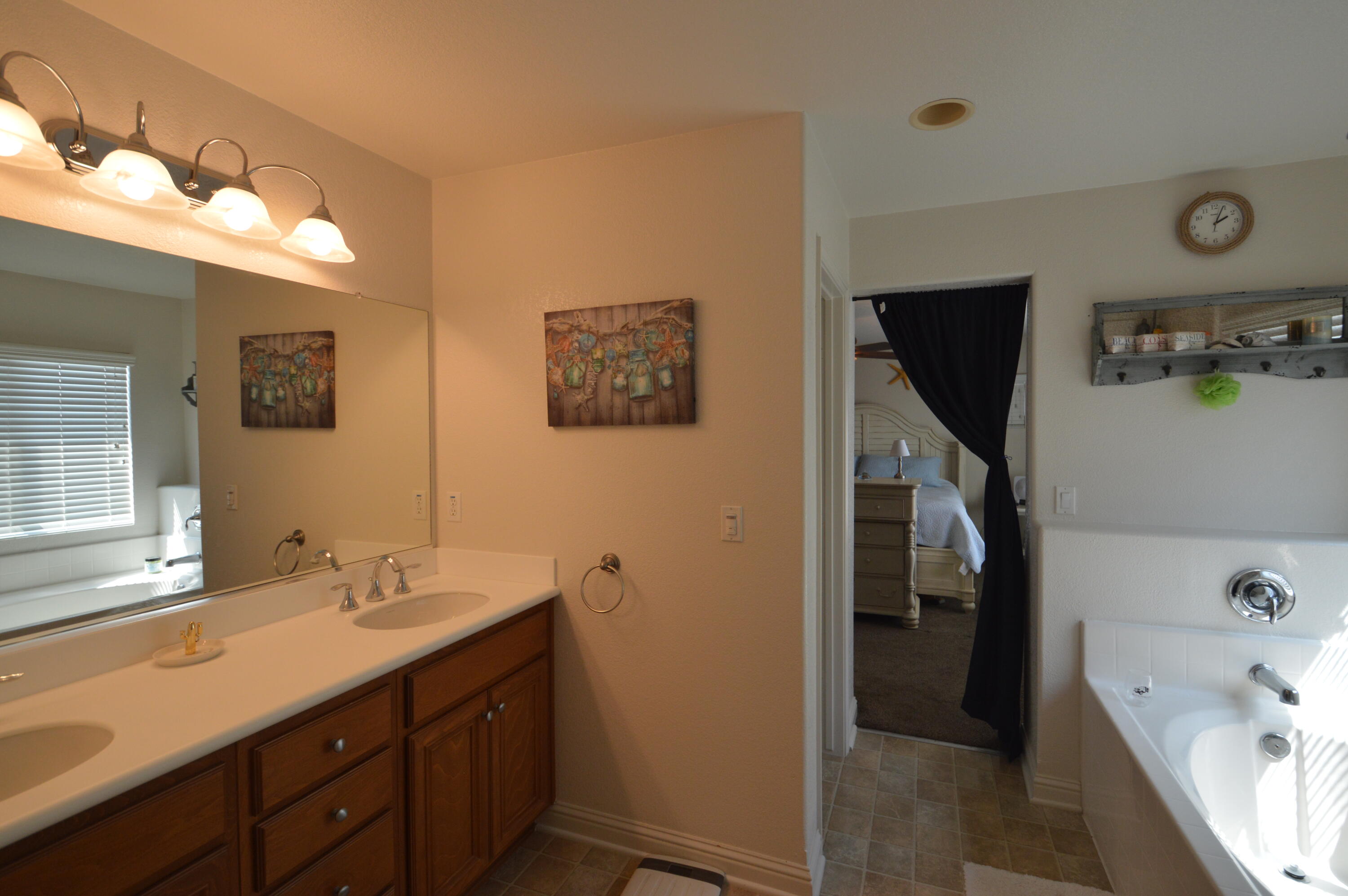 2316 Point Sal Loop Lompoc, CA 93436 - Photo 26 of 36 a bathroom with a tub sink and mirror