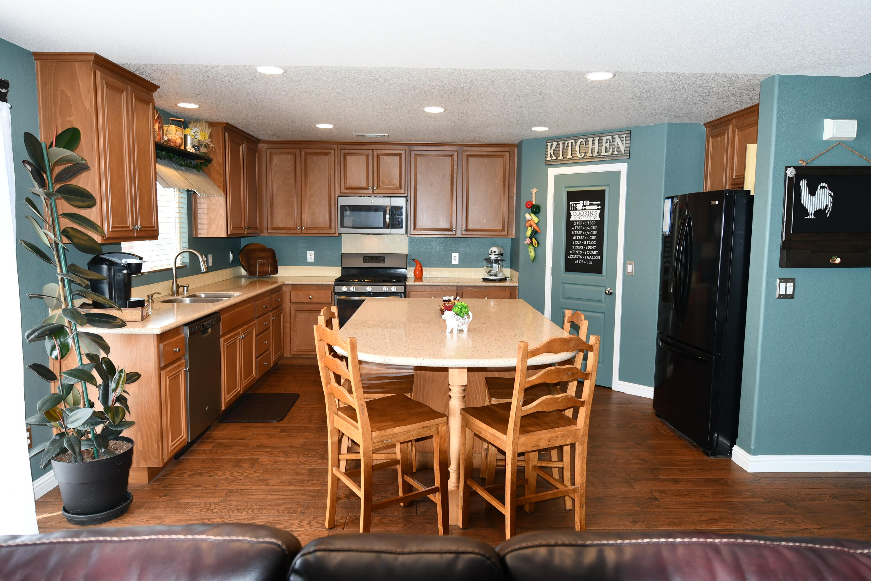 2316 Point Sal Loop Lompoc, CA 93436 - Photo 7 of 36 a dining room with stainless steel appliances kitchen island granite countertop a table chairs and a refrigerator