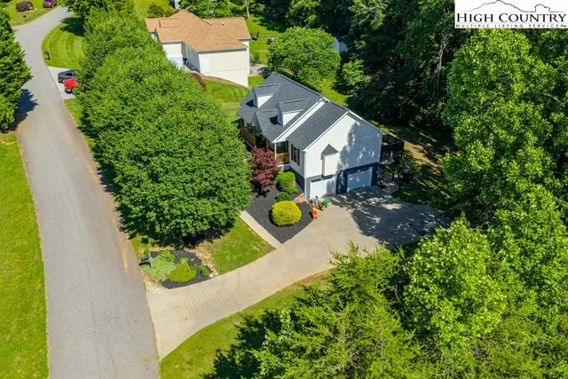 an aerial view of a house with yard swimming pool and outdoor seating