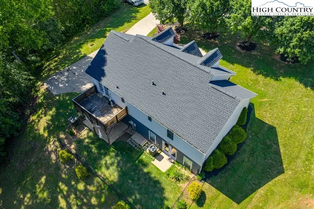 an aerial view of a house with swimming pool and garden