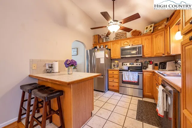 a kitchen with stainless steel appliances a stove a sink dishwasher and a refrigerator