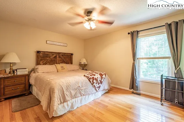 a bedroom with a large bed and a large window