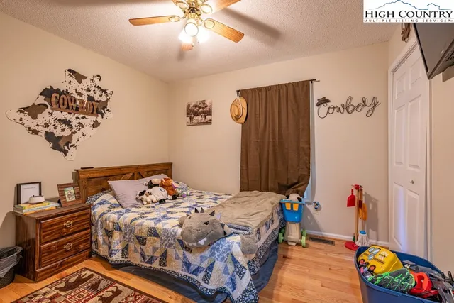 a bedroom with a bed and a chandelier