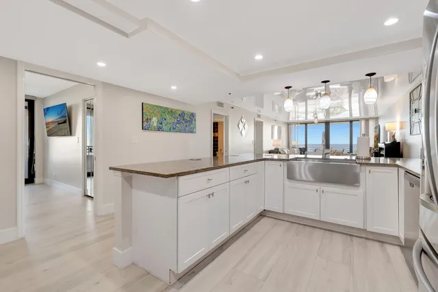 a living room with furniture a large window and a flat screen tv