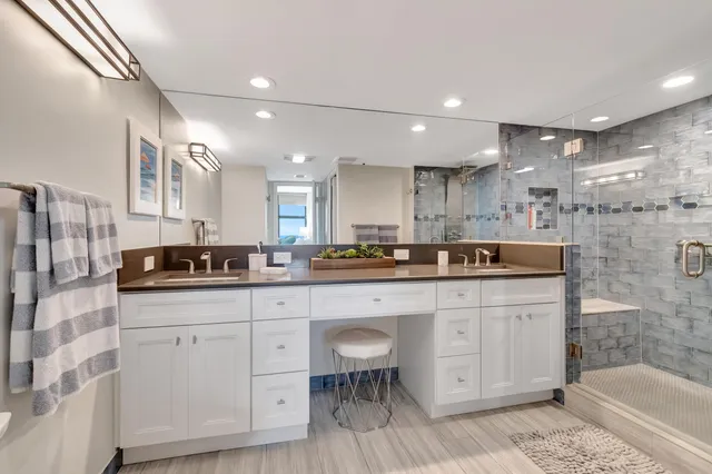 a bathroom with a bathtub shower sink vanity and toilet