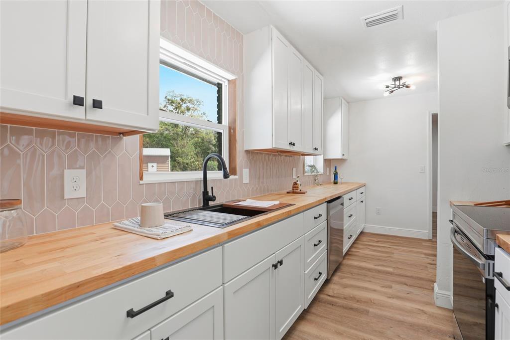 980 Southwest 105th Street Trenton, FL 32693 - Photo 11 of 43 a kitchen with a sink and cabinets