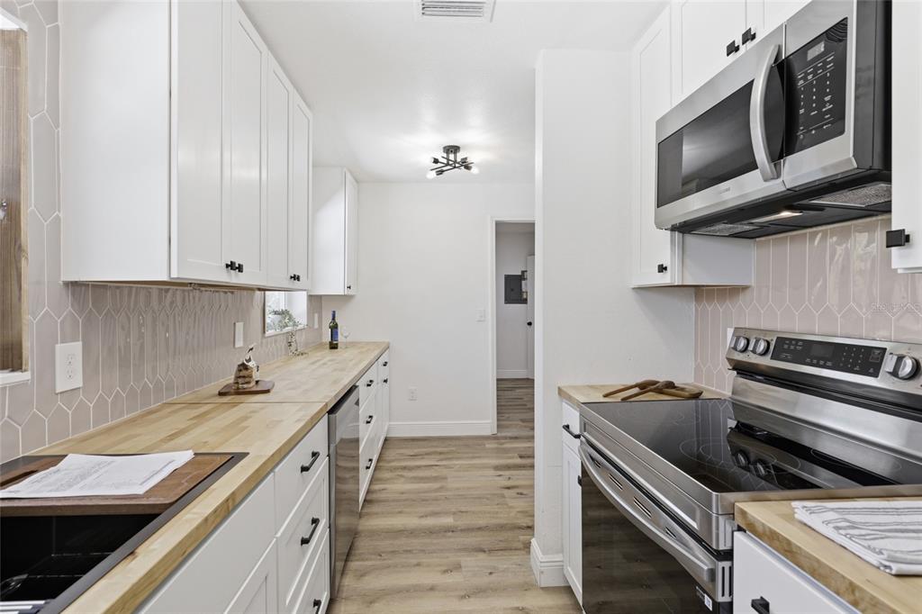 980 Southwest 105th Street Trenton, FL 32693 - Photo 12 of 43 a kitchen with a stove and a microwave