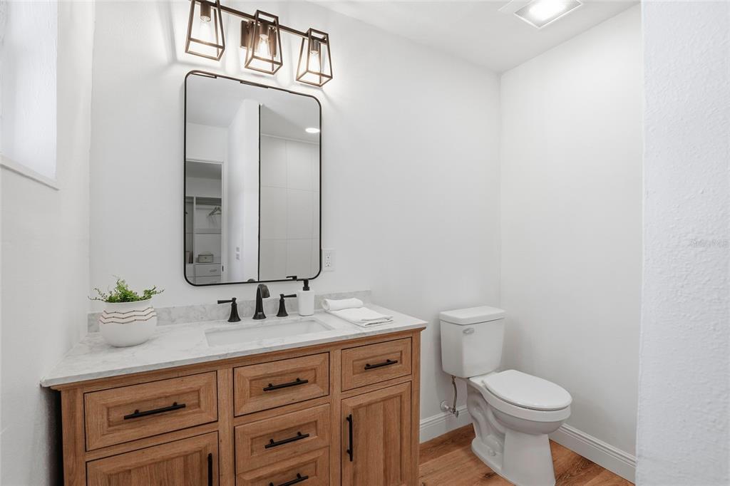 980 Southwest 105th Street Trenton, FL 32693 - Photo 19 of 43 a bathroom with a granite countertop toilet sink and mirror