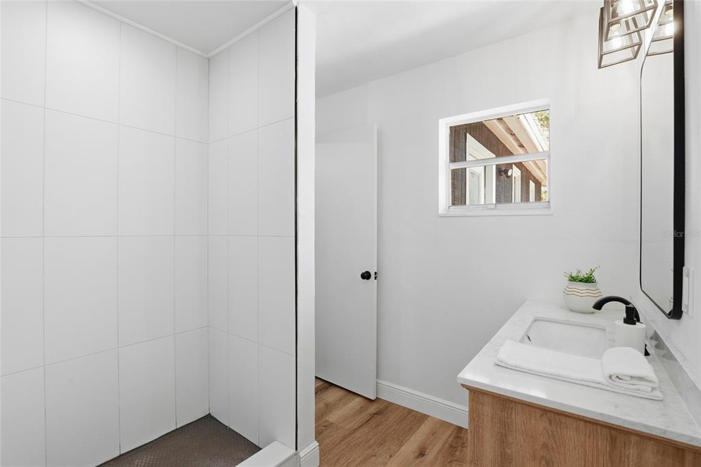 980 Southwest 105th Street Trenton, FL 32693 - Photo 20 of 43 a bathroom with a sink and a wooden floor