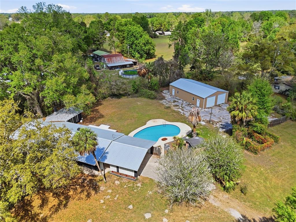 980 Southwest 105th Street Trenton, FL 32693 - Photo 2 of 43 an aerial view of a house with garden space and street view