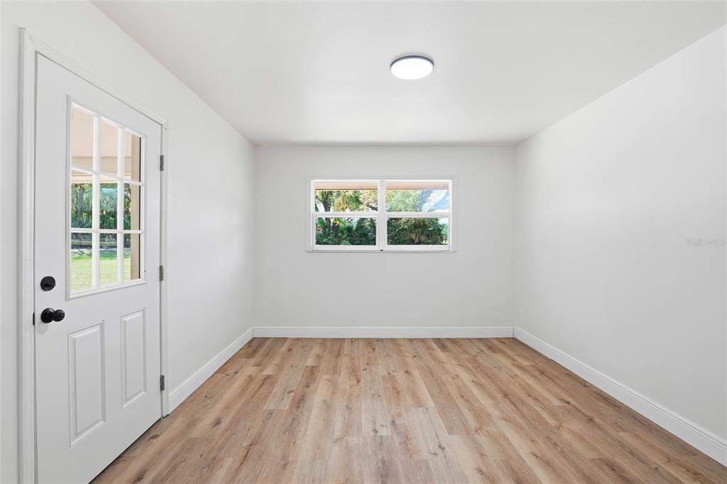 980 Southwest 105th Street Trenton, FL 32693 - Photo 21 of 43 an empty room with wooden floor and windows