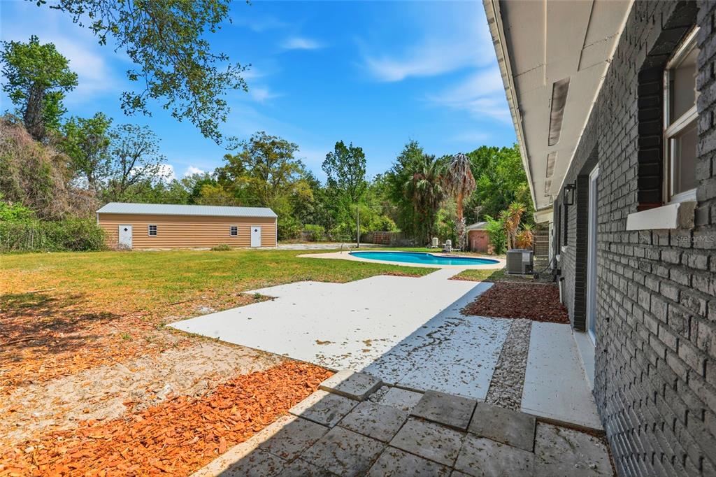 980 Southwest 105th Street Trenton, FL 32693 - Photo 30 of 43 a view of an swimming pool with an outdoor space
