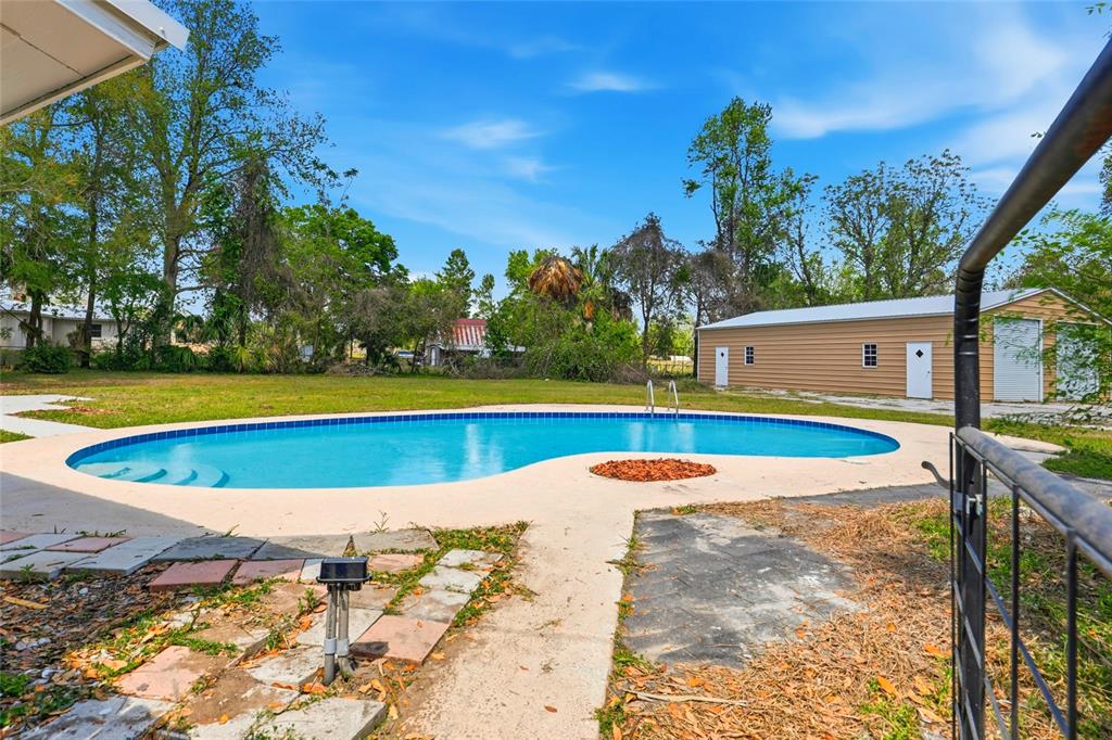 980 Southwest 105th Street Trenton, FL 32693 - Photo 34 of 43 a view of an swimming pool with an outdoor space and seating area