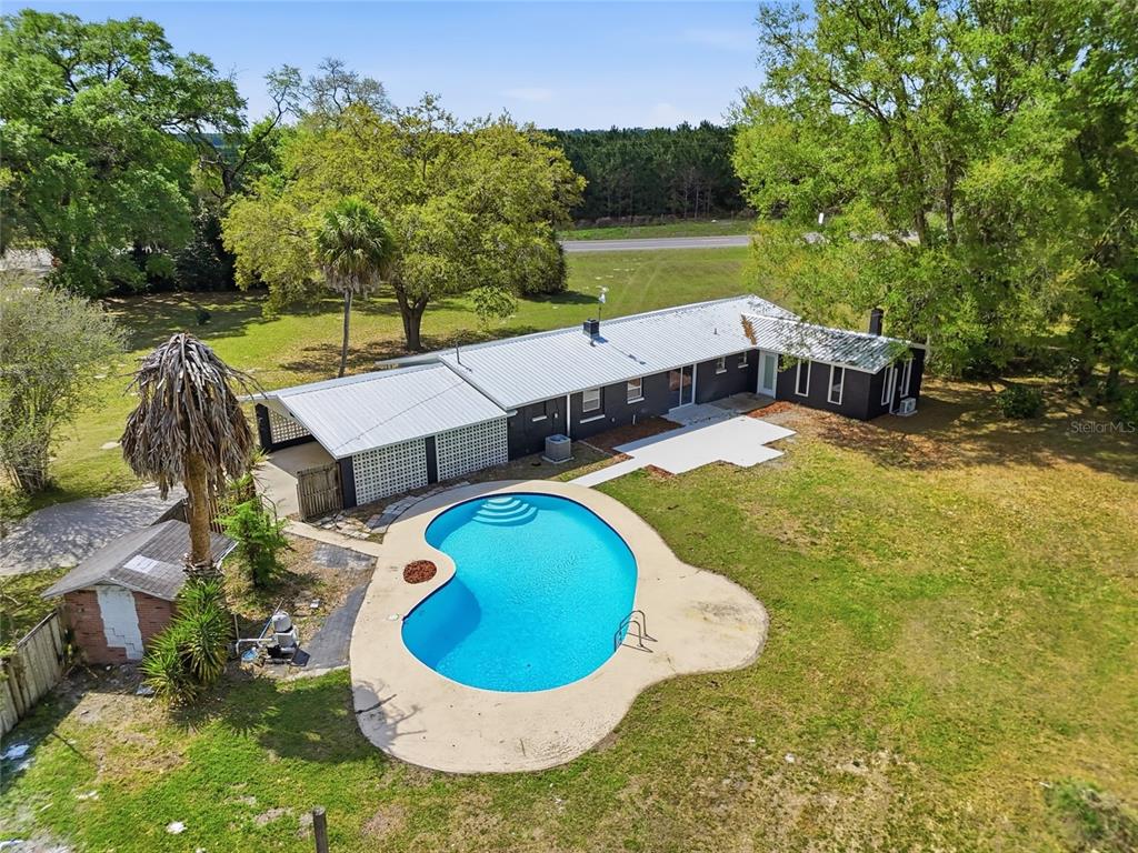 980 Southwest 105th Street Trenton, FL 32693 - Photo 35 of 43 an aerial view of a house with swimming pool and a yard