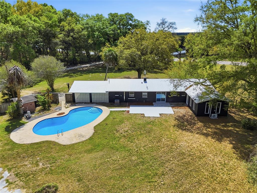 980 Southwest 105th Street Trenton, FL 32693 - Photo 37 of 43 a view of a swimming pool with a patio and a yard