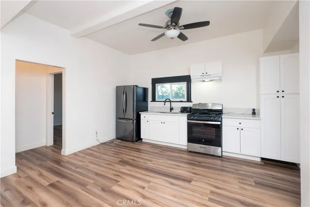 a kitchen with a refrigerator sink and stove