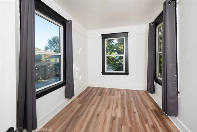 a view of outdoor space with wooden floor and windows