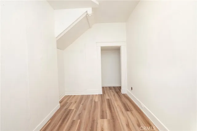 a view of a room with wooden floor