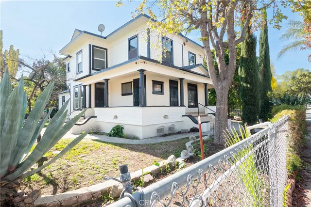 a front view of a house with swimming pool and glass windows
