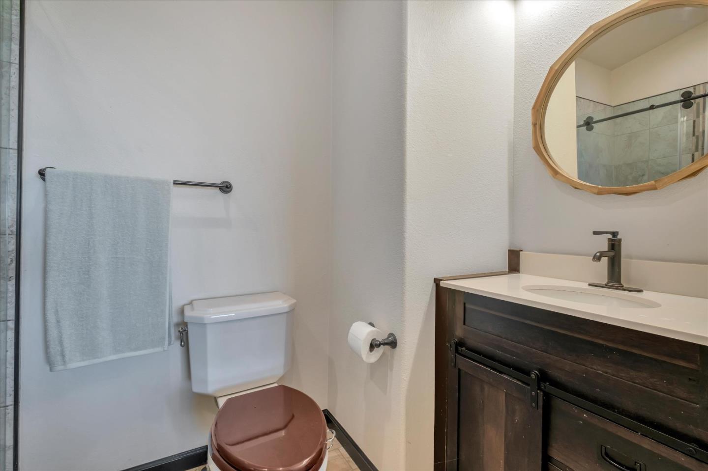 620 Maymens Flat Road Los Gatos, CA 95033 - Photo 23 of 42 a bathroom with a toilet a sink and mirror