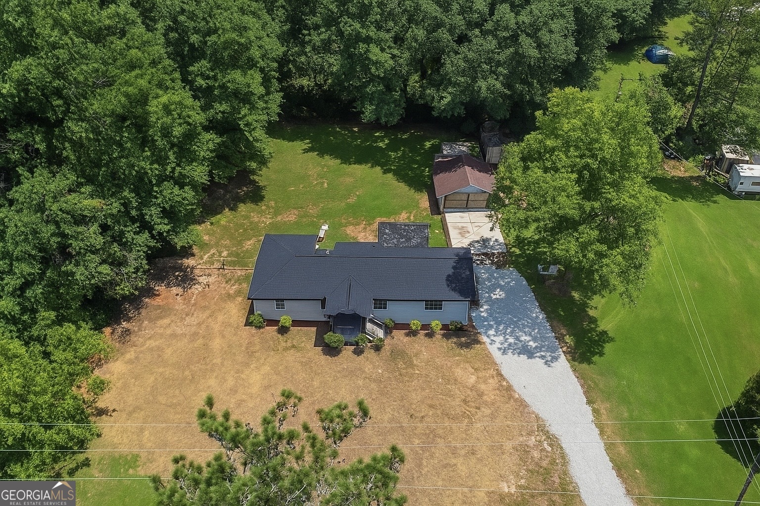 an aerial view of a house with a yard