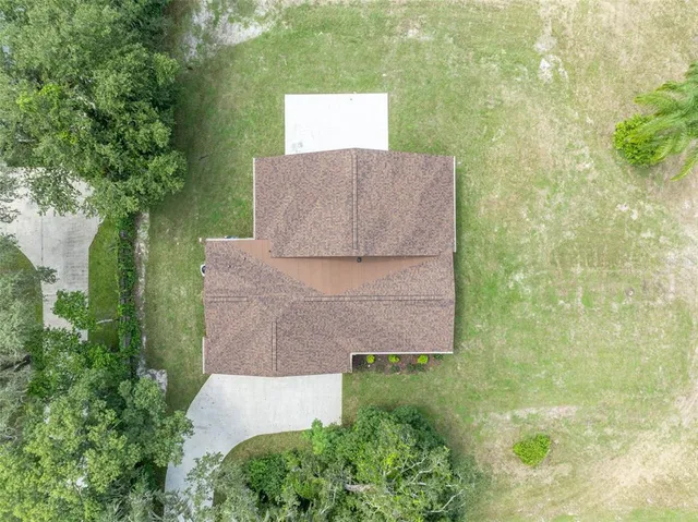 an aerial view of a house with a yard