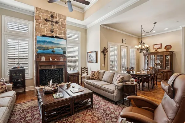 a living room with furniture fireplace and a large window