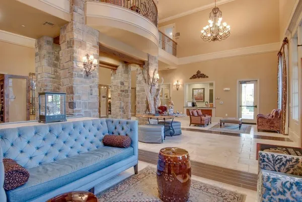 a living room with furniture and a chandelier