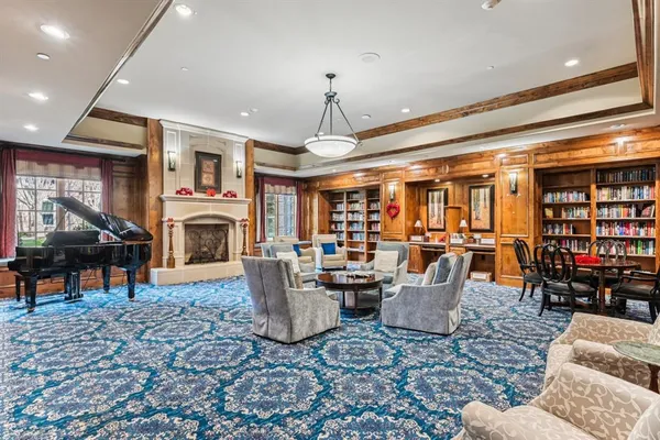 a living room with lots of furniture and a fireplace