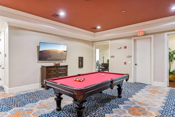 a room with pool table and flat screen tv