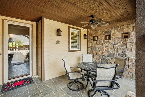 a view of a dining room with furniture and chandelier