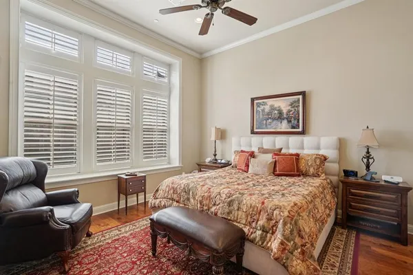 a bedroom with a bed a couch and a window