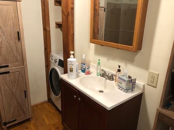 69 Pine Road Charlton, MA 01507 - Photo 15 of 26 a bathroom with sink a mirror a washer and dryer