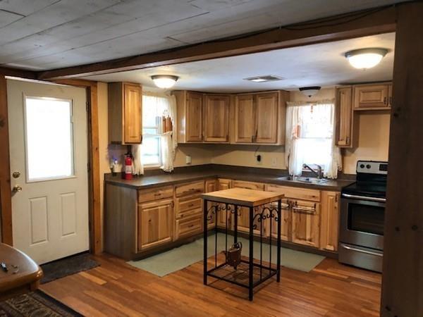 69 Pine Road Charlton, MA 01507 - Photo 20 of 26 a kitchen with stainless steel appliances granite countertop a stove a sink and a refrigerator