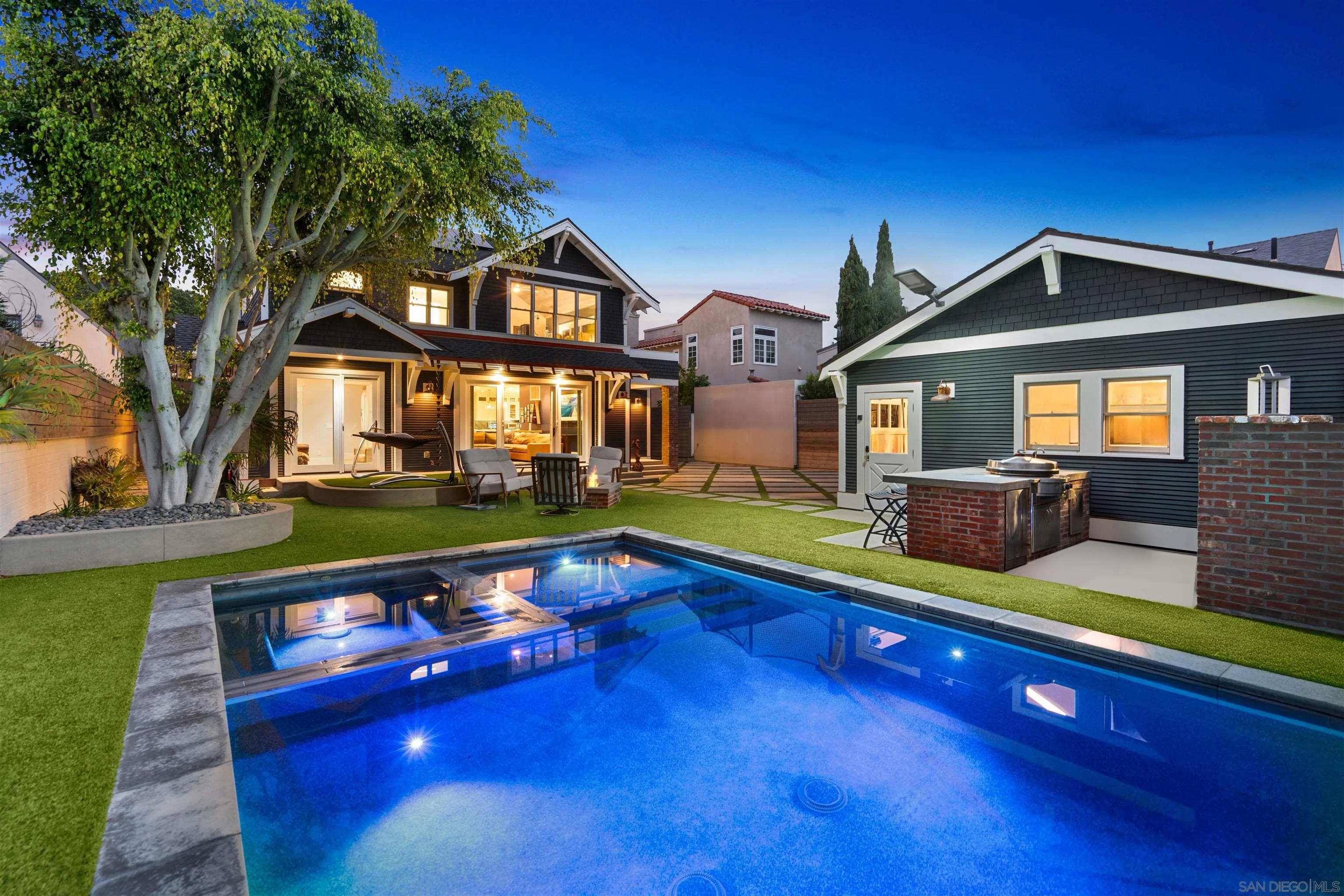 a front view of house with yard and outdoor seating