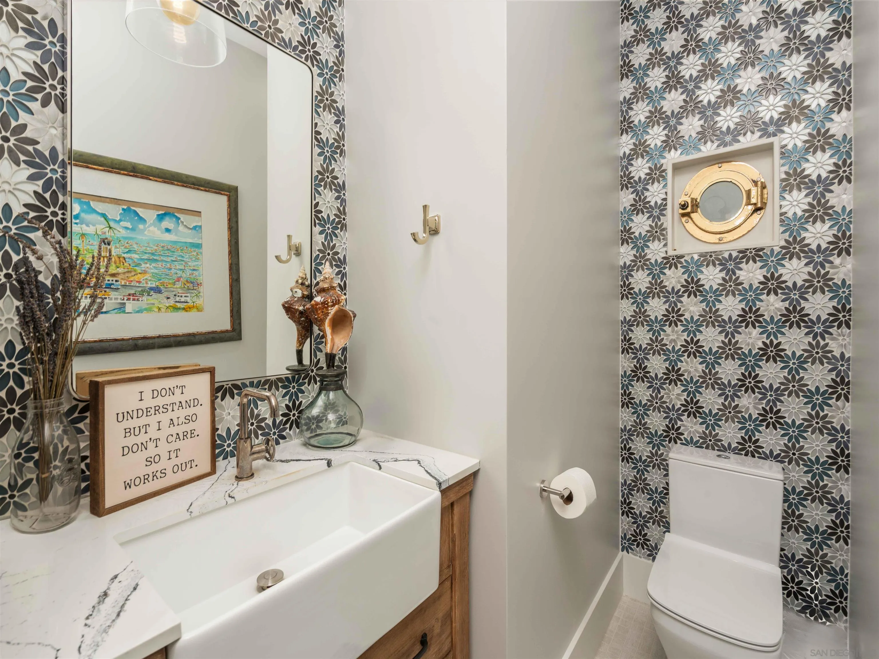 1027 G Avenue Coronado, CA 92118 - Photo 12 of 59 a bathroom with a sink toilet and window
